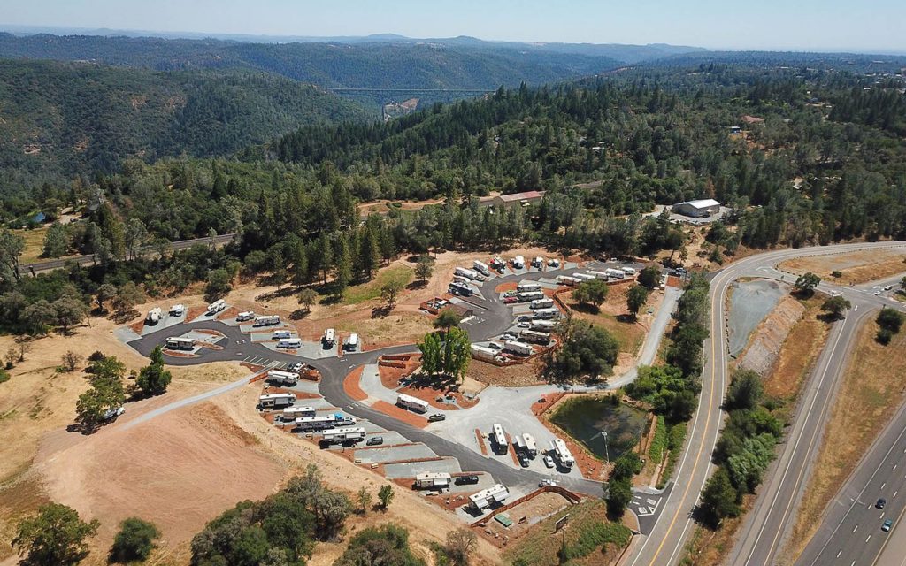 Wide view of Auburn RV Resort grounds with RV sites and oak trees