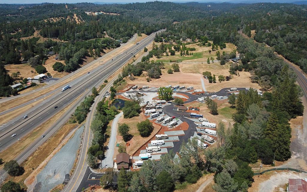 Motorhomes on spacious sites at Auburn RV Resort with golden Sierra foothills at sunset
